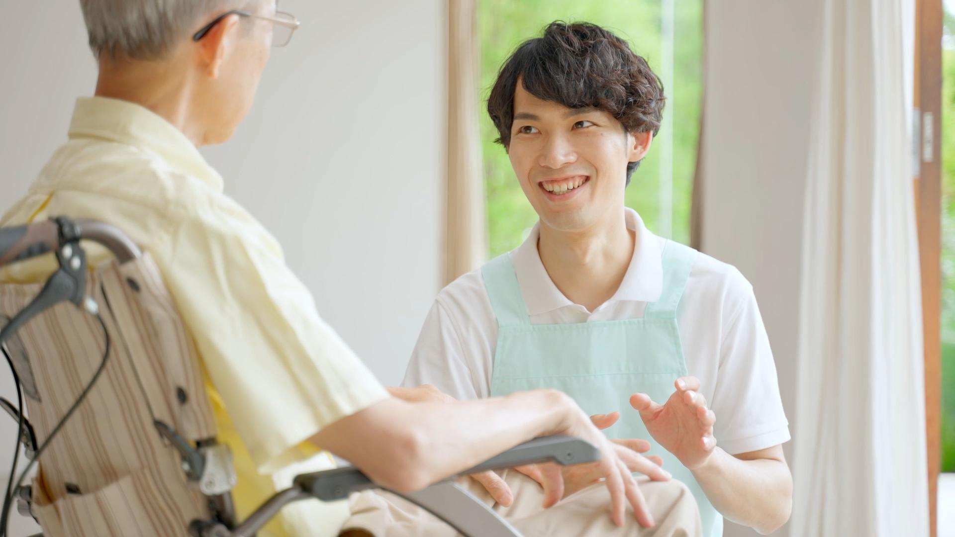 portrait of old man and young caregiver in the nusing home